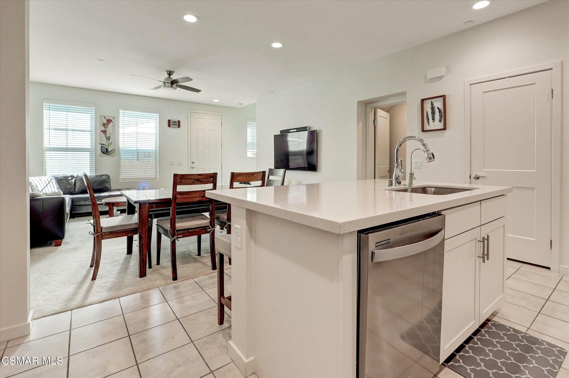 310 Farmhouse Drive, Unit 4 Simi Valley, CA 93065 - Photo 11 of 29 a kitchen with stainless steel appliances kitchen island granite countertop a sink and cabinets