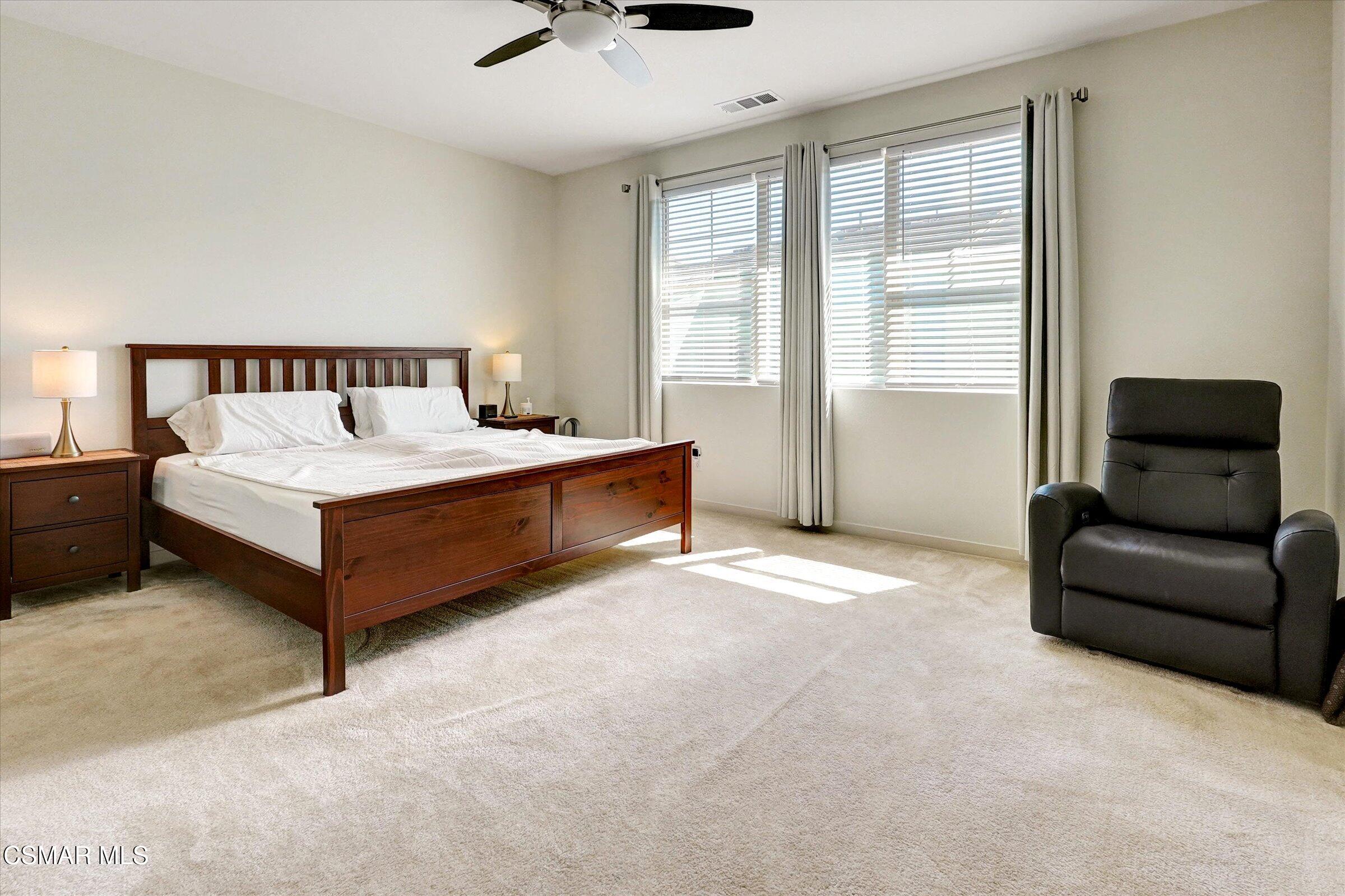 310 Farmhouse Drive, Unit 4 Simi Valley, CA 93065 - Photo 14 of 29 a spacious bedroom with a bed and a couch