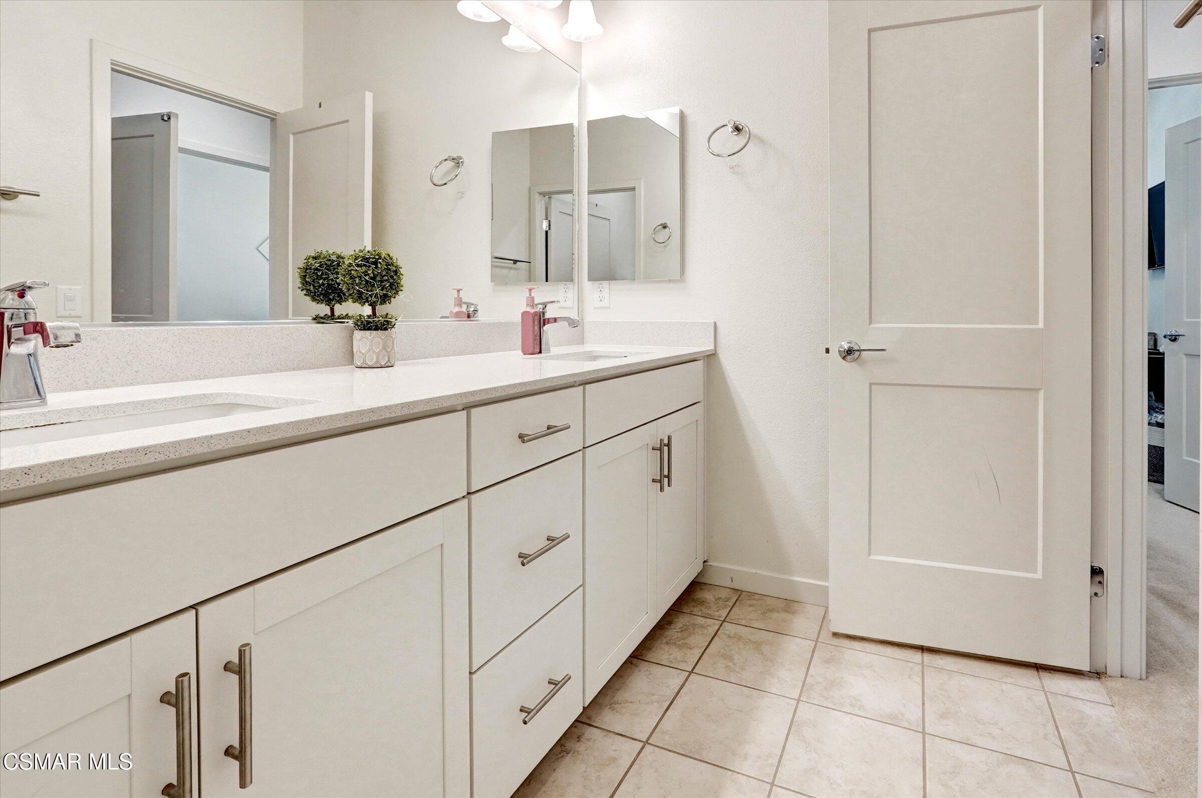 310 Farmhouse Drive, Unit 4 Simi Valley, CA 93065 - Photo 17 of 29 a spacious bathroom with a double vanity sink a mirror and a shower