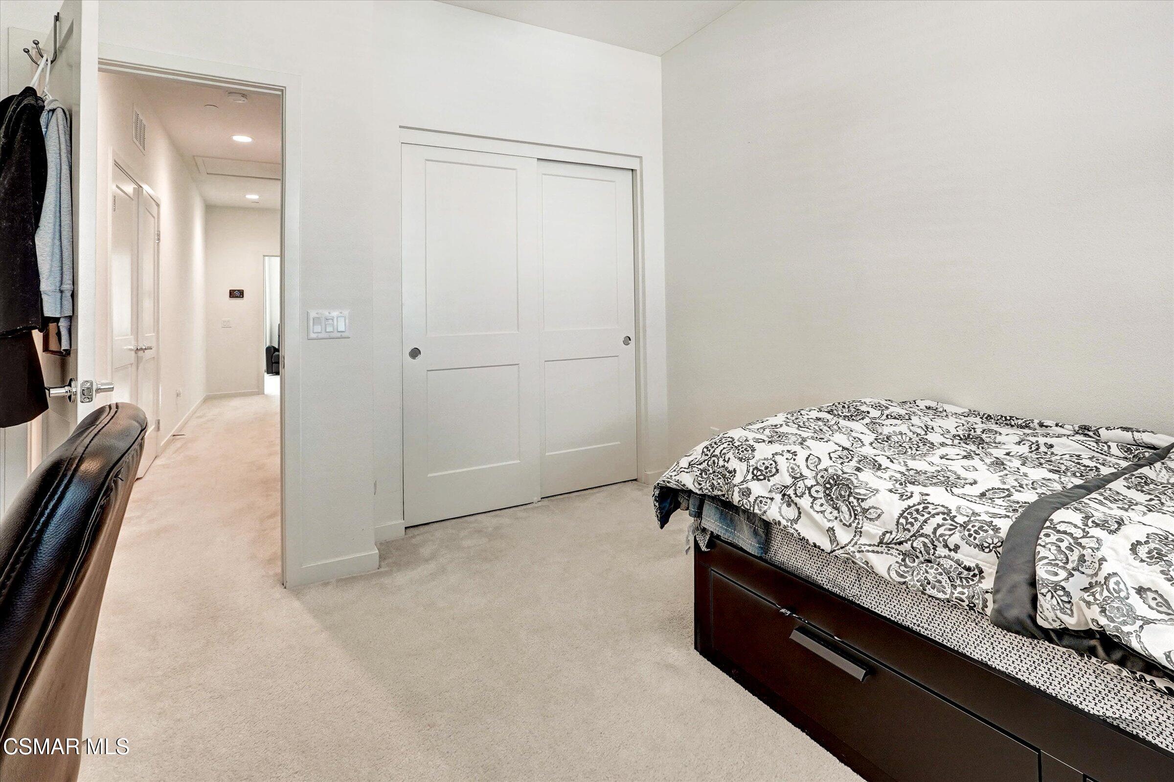 310 Farmhouse Drive, Unit 4 Simi Valley, CA 93065 - Photo 18 of 29 a bedroom with a bed and a flat screen tv