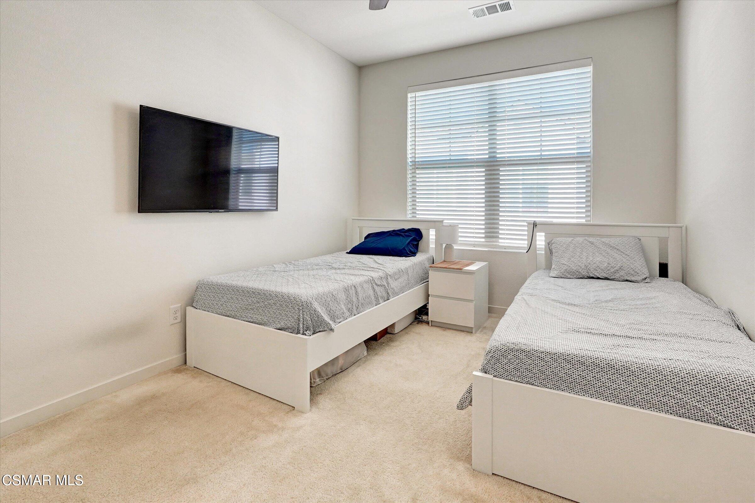 310 Farmhouse Drive, Unit 4 Simi Valley, CA 93065 - Photo 19 of 29 a bedroom with a bed and a flat screen tv