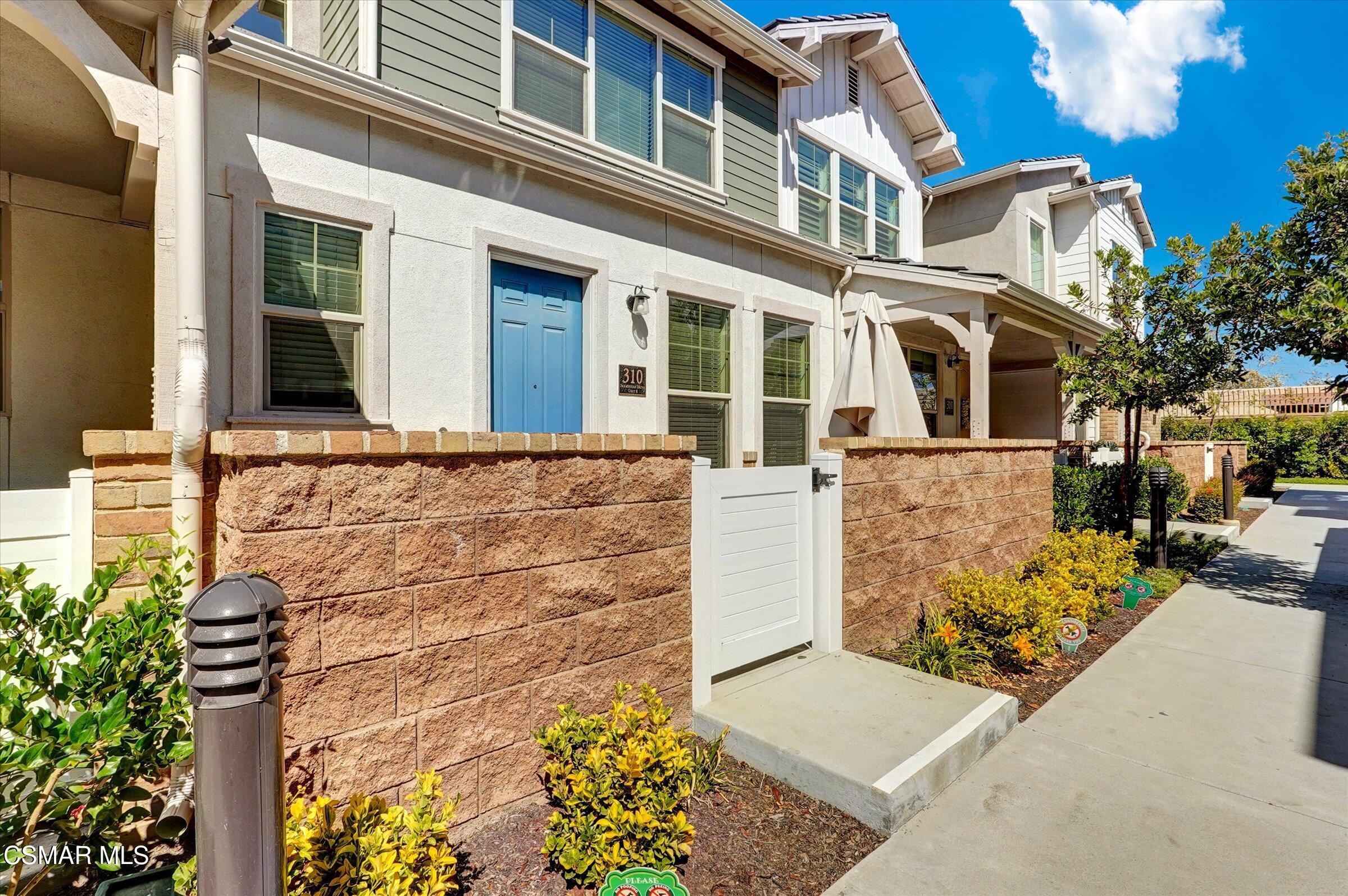 310 Farmhouse Drive, Unit 4 Simi Valley, CA 93065 - Photo 2 of 29 front view of a brick house with a street
