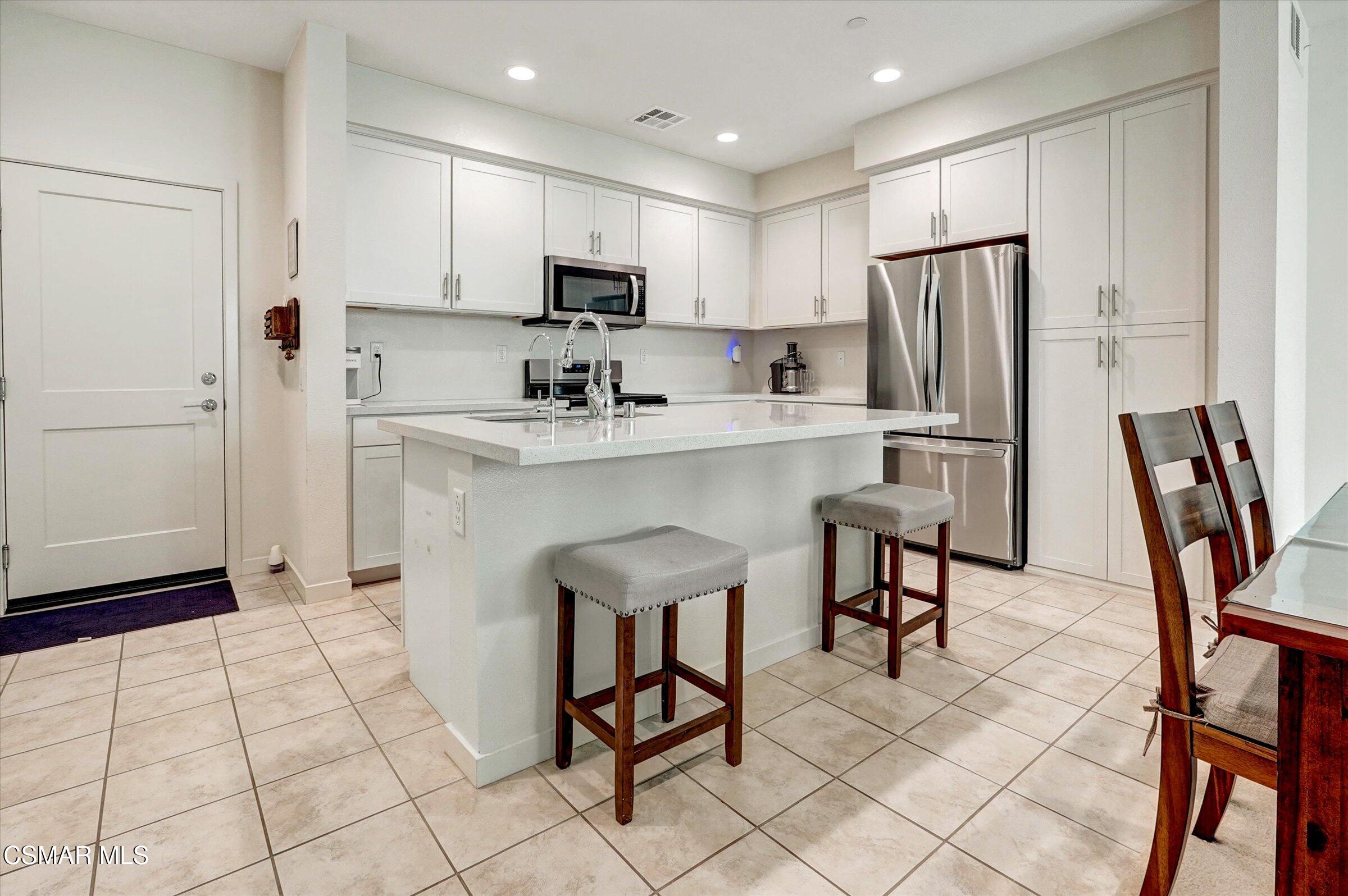 310 Farmhouse Drive, Unit 4 Simi Valley, CA 93065 - Photo 7 of 29 a kitchen with stainless steel appliances a refrigerator sink and cabinets