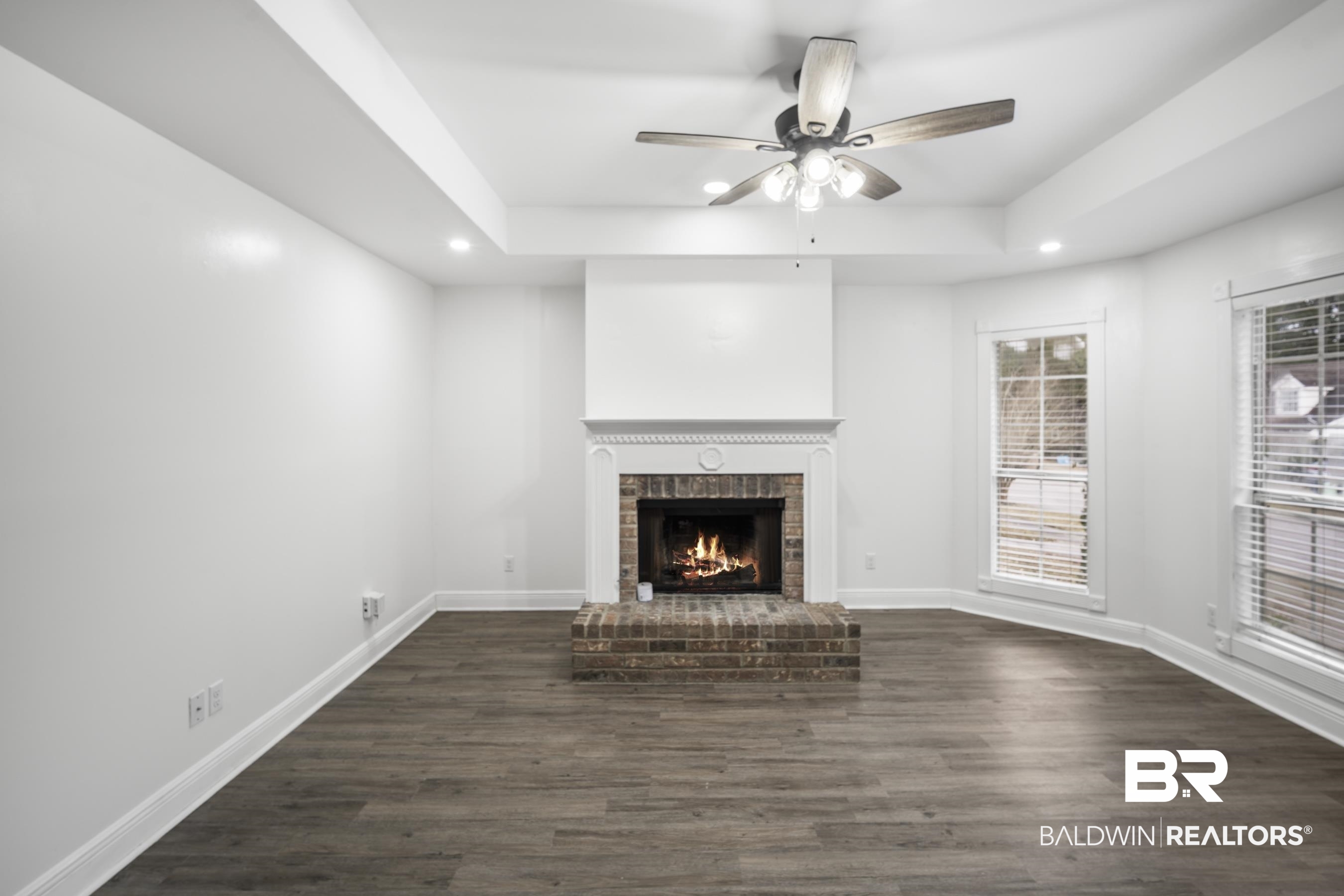 3101 Autumn Ridge Drive West Mobile, AL 36695 - Photo 2 of 36 Unfurnished living room with recessed lighting, dark wood-style flooring, a ceiling fan, a fireplace, and a tray ceiling