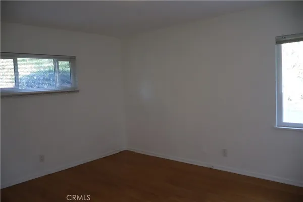 a bathroom with a granite countertop sink and a washing machine