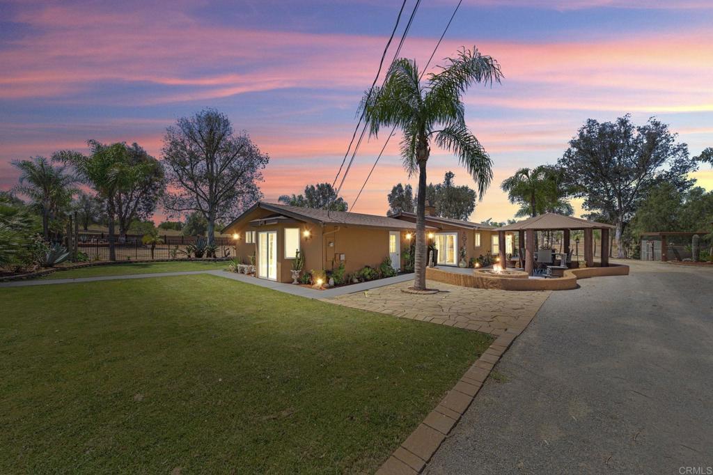 30265 Miller Road Valley Center, CA 92082 - Photo 5 of 56 a front view of a house with a garden and yard
