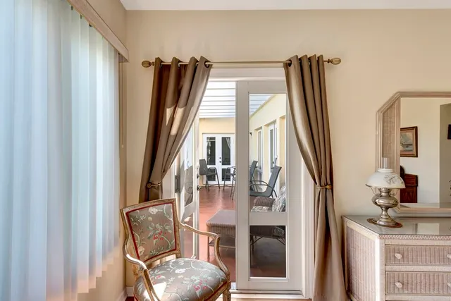 a bedroom with two large bed and a chandelier