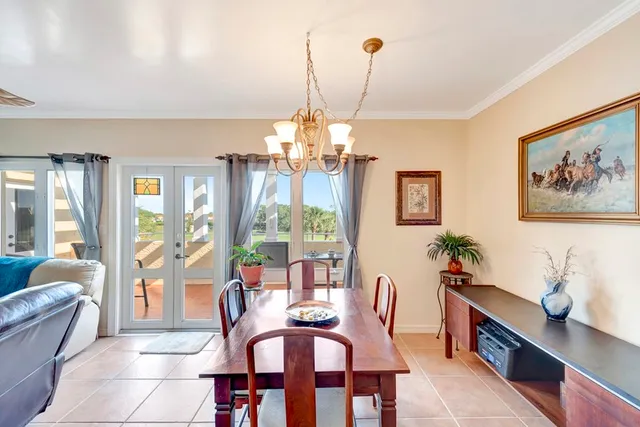 a kitchen with cabinets and chairs