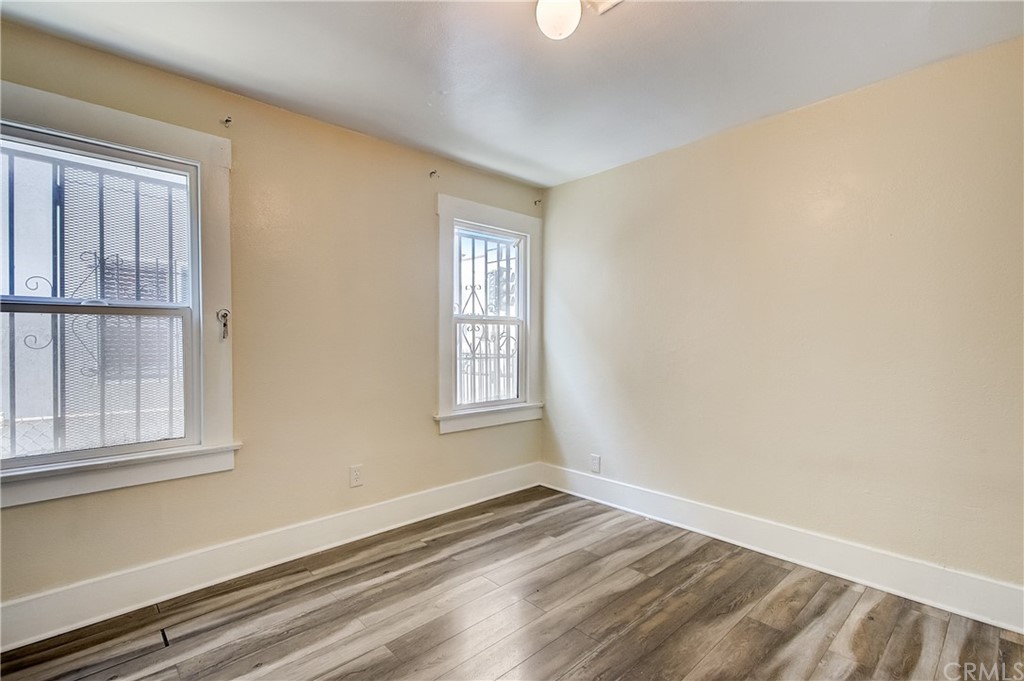 4708 San Pedro Street Los Angeles, CA 90011 - Photo 12 of 19 a view of an empty room with wooden floor and a window