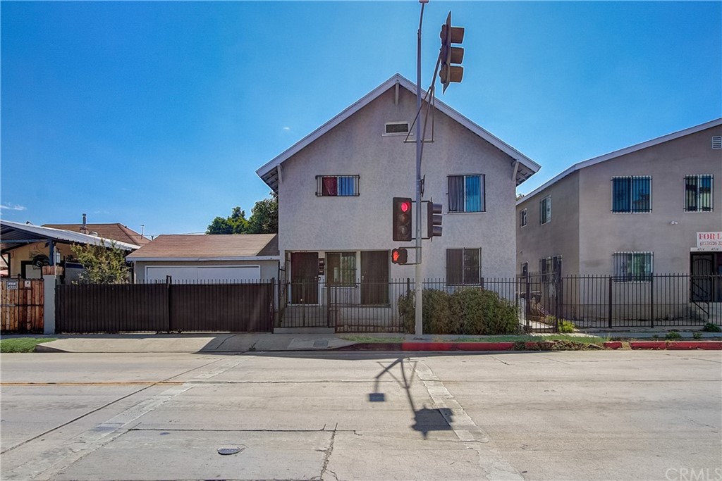 4708 San Pedro Street Los Angeles, CA 90011 - Photo 18 of 19 a front view of a house with a yard and garage