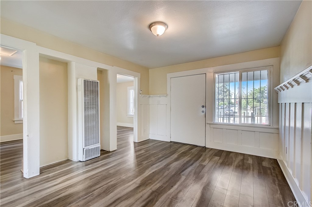 4708 San Pedro Street Los Angeles, CA 90011 - Photo 4 of 19 an empty room with wooden floor and windows