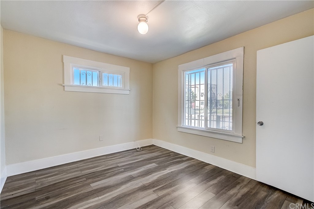 4708 San Pedro Street Los Angeles, CA 90011 - Photo 7 of 19 a view of empty room with wooden floor and fan