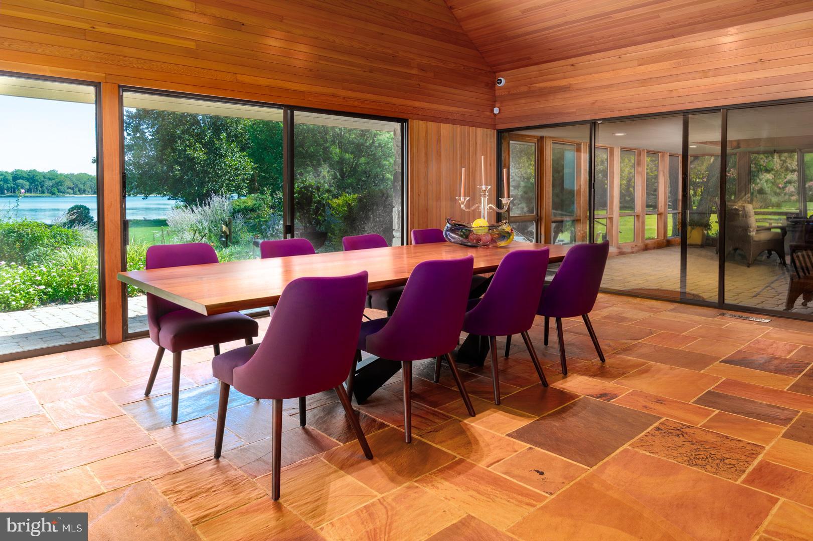3207 Bennett Point Road Queenstown, MD 21658 - Photo 13 of 69 a view of a patio with a dining table and chairs