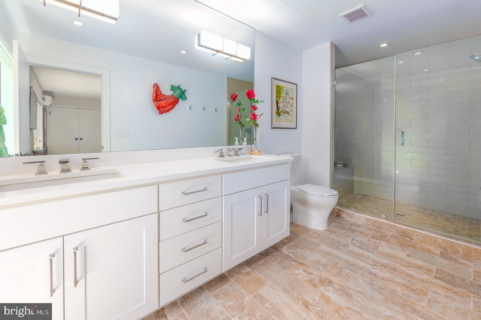 3207 Bennett Point Road Queenstown, MD 21658 - Photo 24 of 69 a spacious bathroom with double vanity a mirror a vanity and a shower