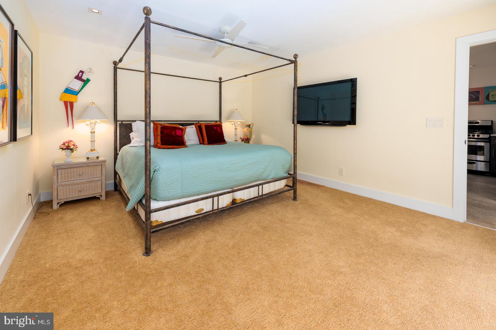 3207 Bennett Point Road Queenstown, MD 21658 - Photo 25 of 69 a bedroom with a bed and a flat screen tv