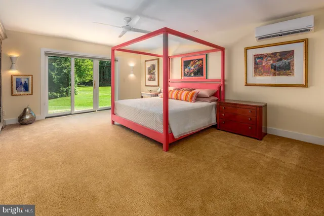a spacious bathroom with a sink mirror and toilet