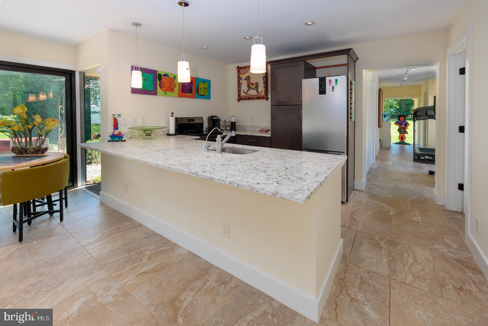 3207 Bennett Point Road Queenstown, MD 21658 - Photo 30 of 69 a living room with granite countertop furniture and a flat screen tv