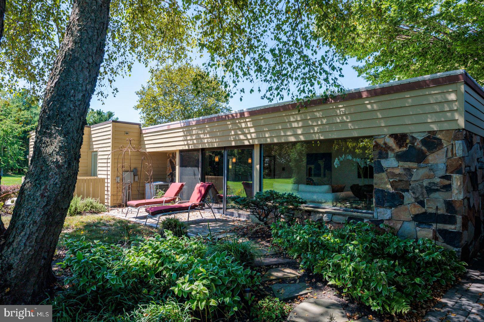 3207 Bennett Point Road Queenstown, MD 21658 - Photo 32 of 69 a view of a patio with table and chairs under an umbrella