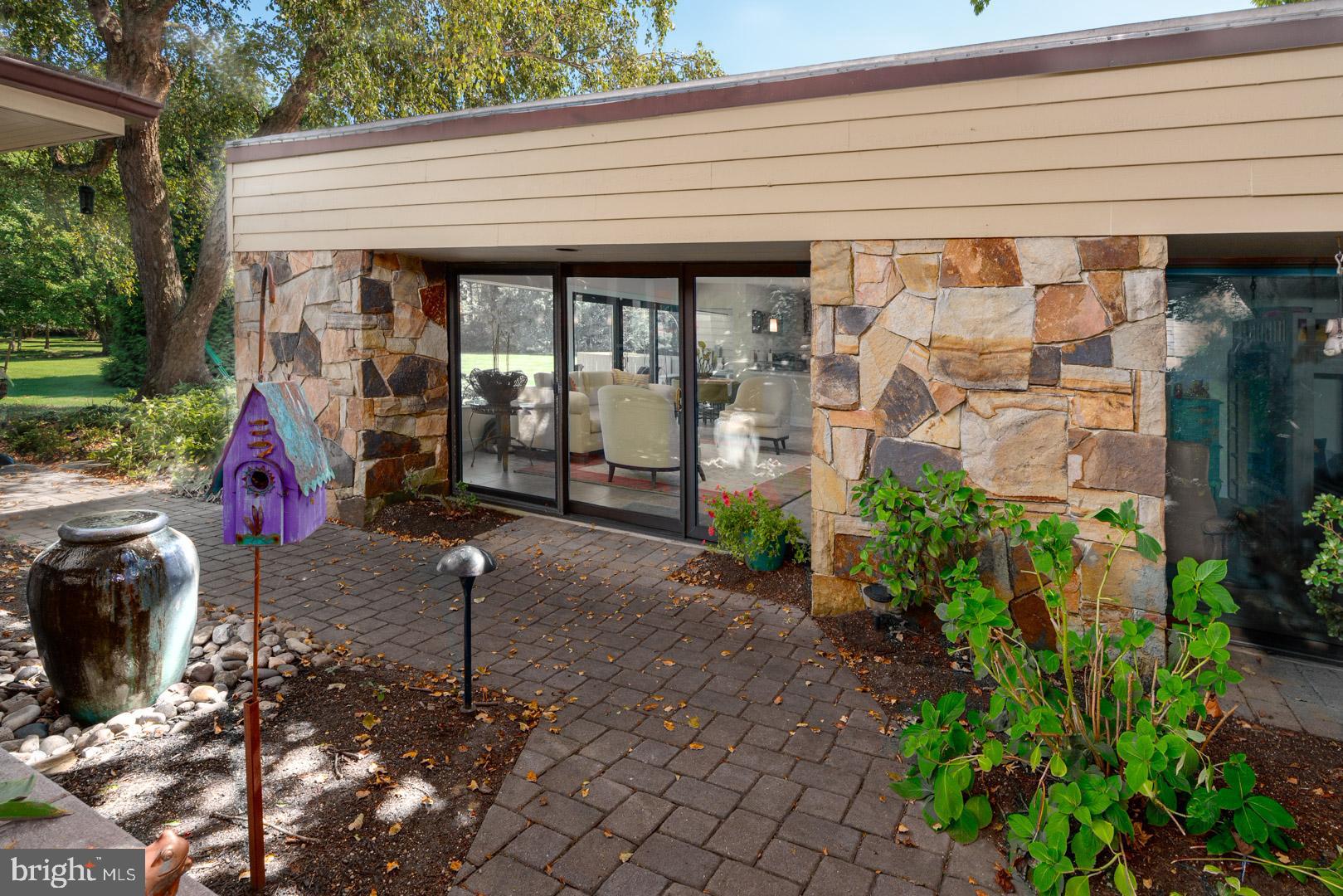 3207 Bennett Point Road Queenstown, MD 21658 - Photo 34 of 69 a view of a porch with furniture and floor to ceiling window and garden