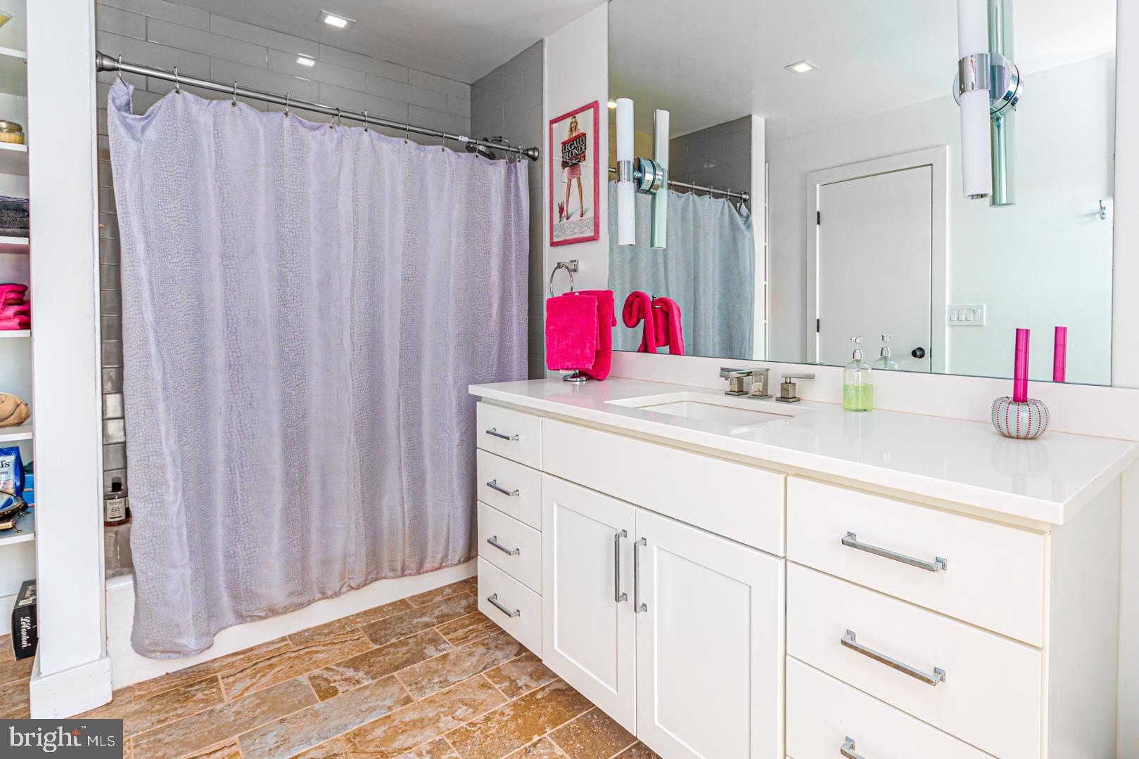 3207 Bennett Point Road Queenstown, MD 21658 - Photo 37 of 69 a bathroom with a sink vanity and a shower