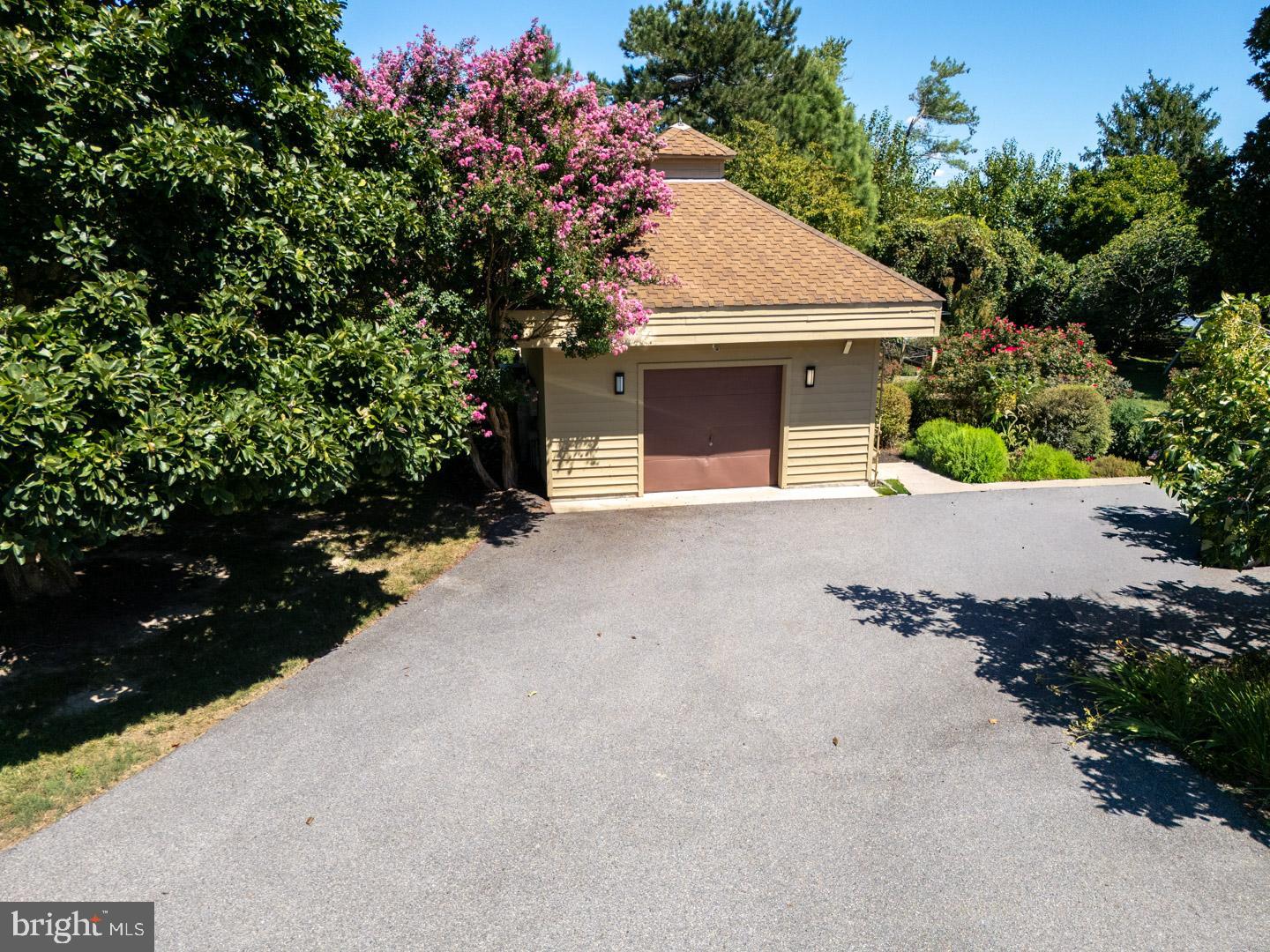 3207 Bennett Point Road Queenstown, MD 21658 - Photo 38 of 69 a front view of a house with a yard and garage