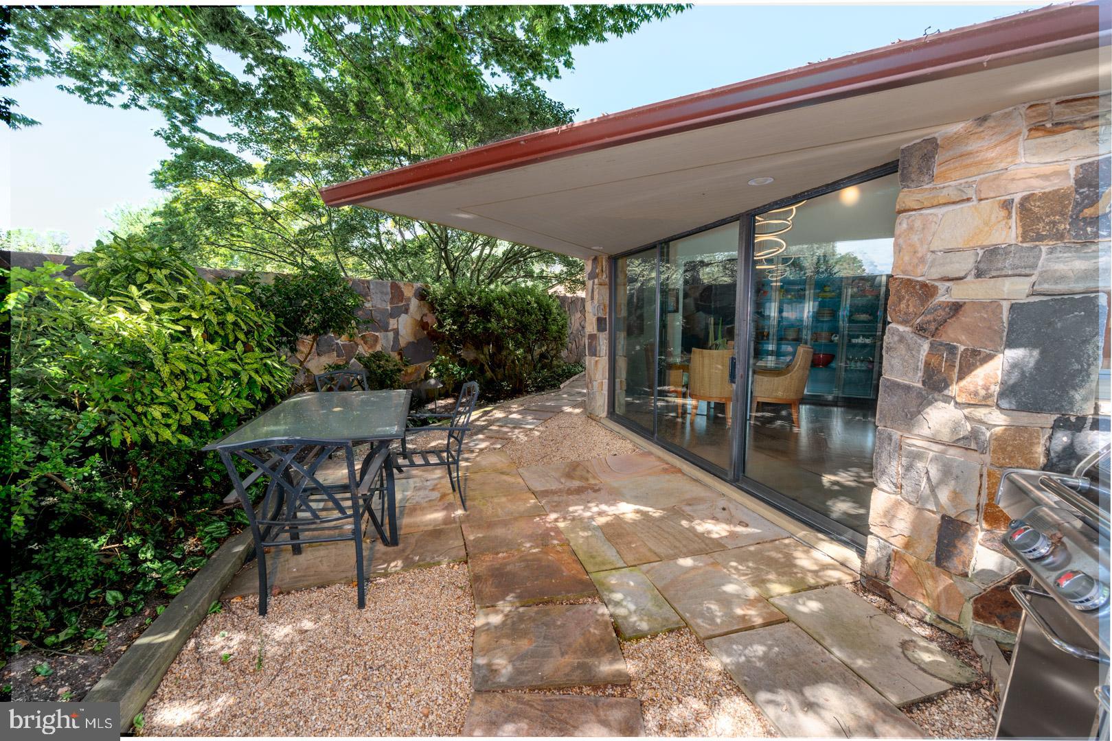 3207 Bennett Point Road Queenstown, MD 21658 - Photo 43 of 69 a view of a patio with table and chairs under an umbrella