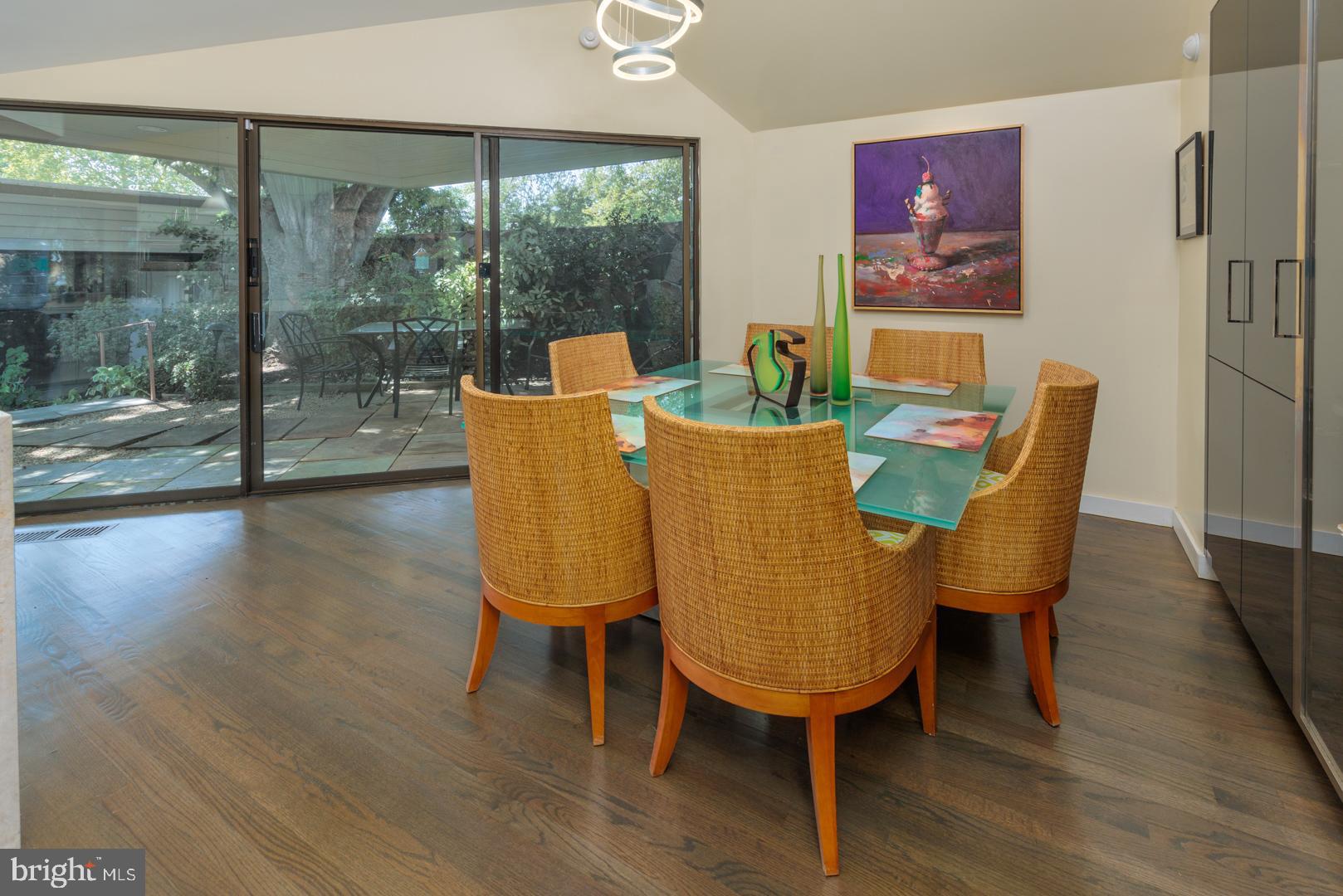 3207 Bennett Point Road Queenstown, MD 21658 - Photo 44 of 69 a dining room with furniture a chandelier and wooden floor