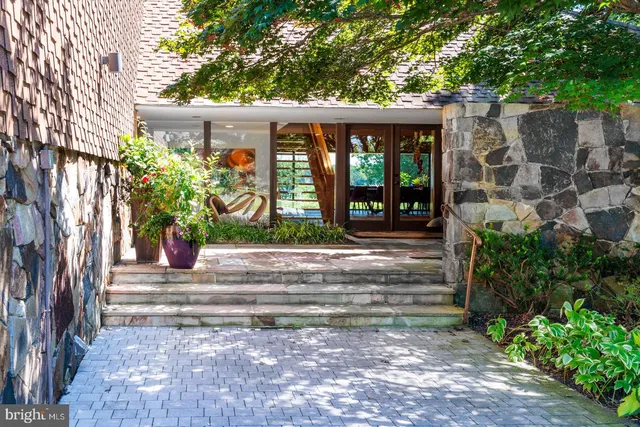 a kitchen with granite countertop white cabinets and a large window