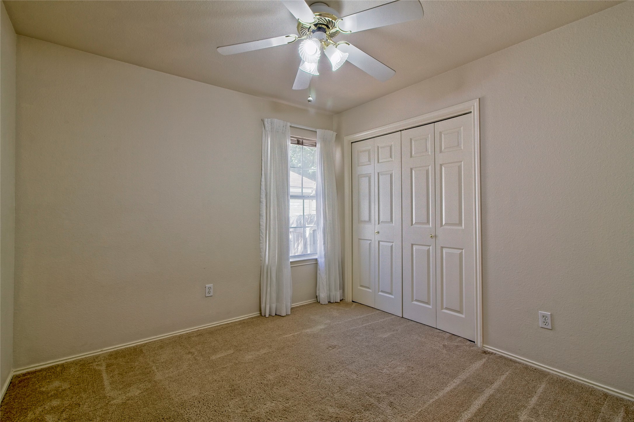 108 Rio Vista Drive Georgetown, TX 78626 - Photo 21 of 36 Unfurnished bedroom with carpet flooring, a ceiling fan, and a closet