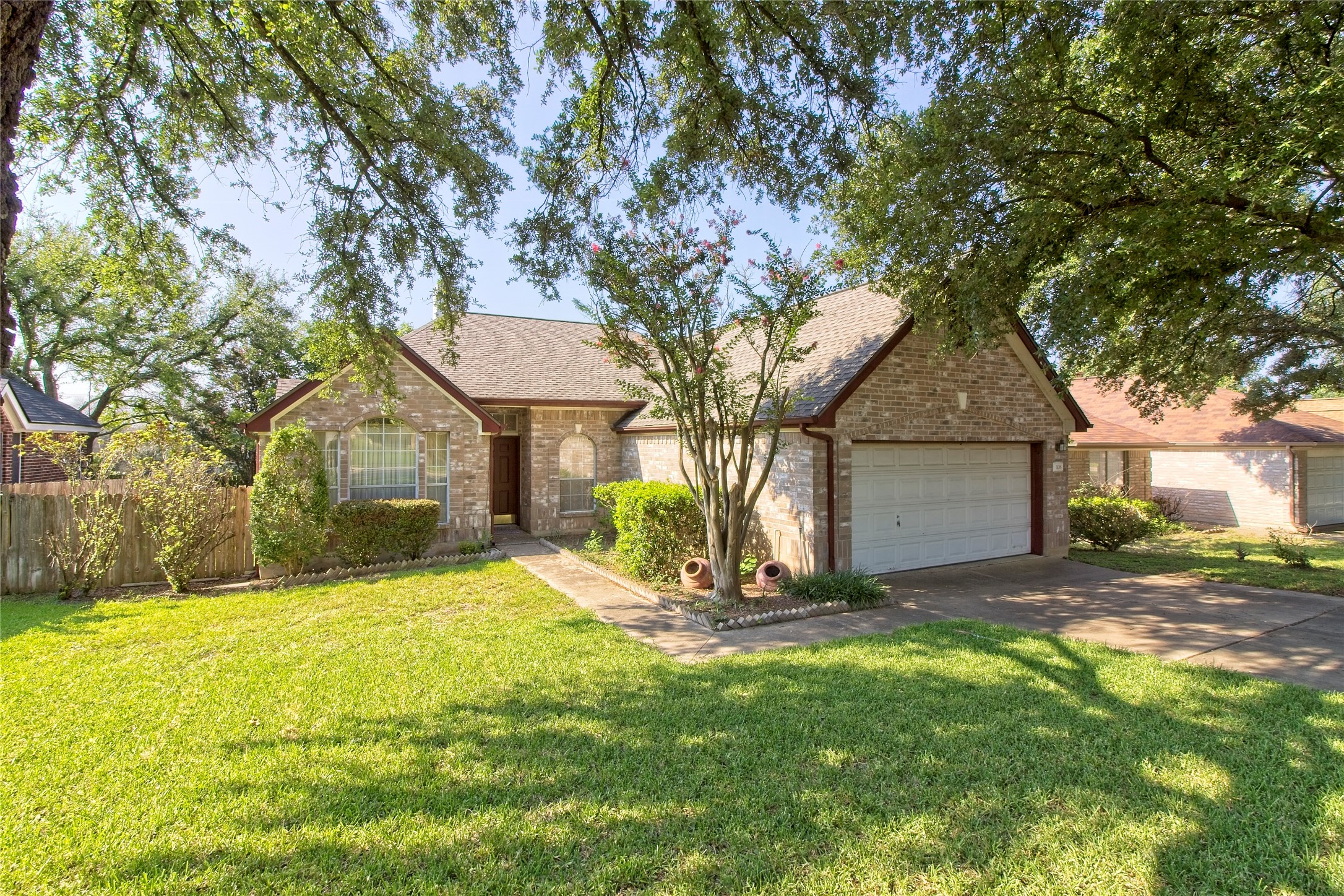 108 Rio Vista Drive Georgetown, TX 78626 - Photo 4 of 36 View of front of property with brick siding, roof with shingles, concrete driveway, and a garage