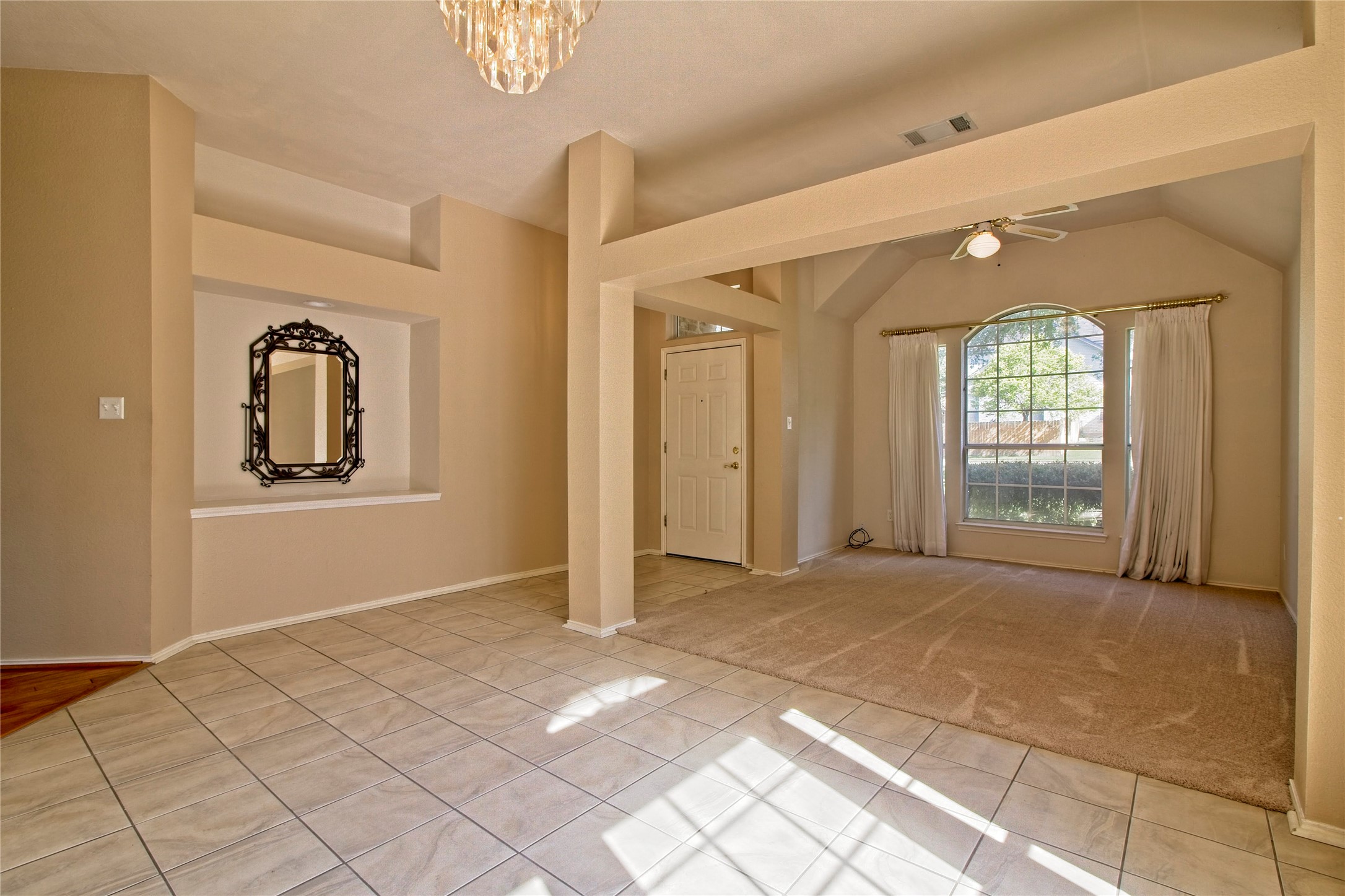 108 Rio Vista Drive Georgetown, TX 78626 - Photo 6 of 36 Empty room featuring light tile patterned floors, a ceiling fan, suspended lighting, and light colored carpet