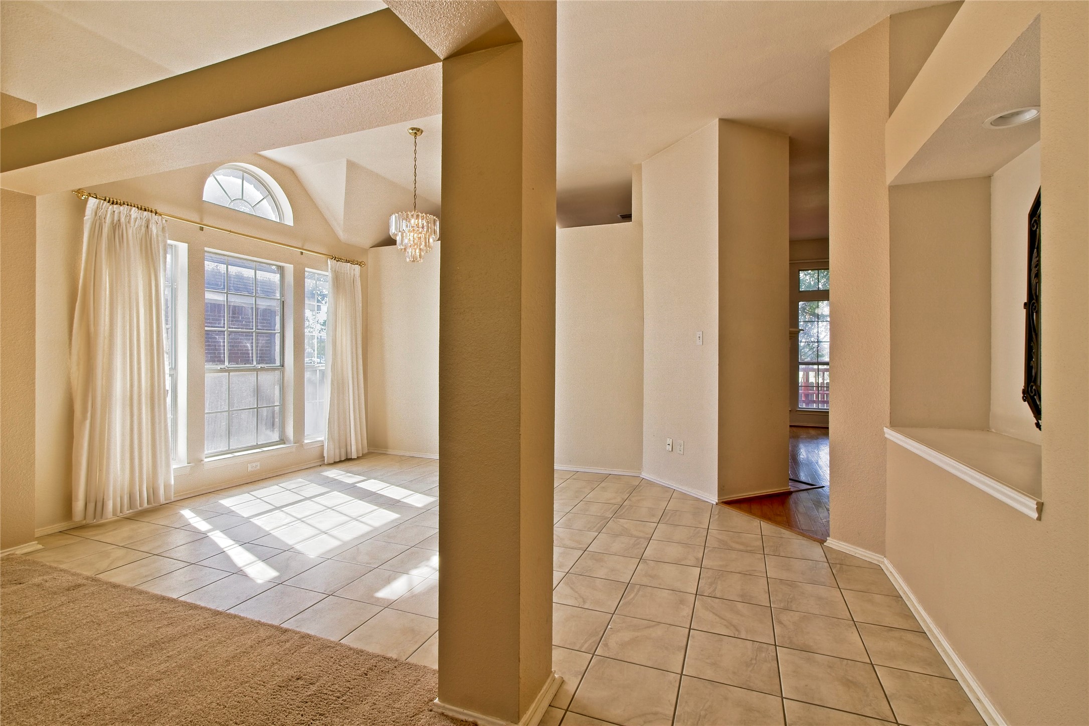 108 Rio Vista Drive Georgetown, TX 78626 - Photo 7 of 36 Entrance foyer with light tile patterned floors, a chandelier, and vaulted ceiling