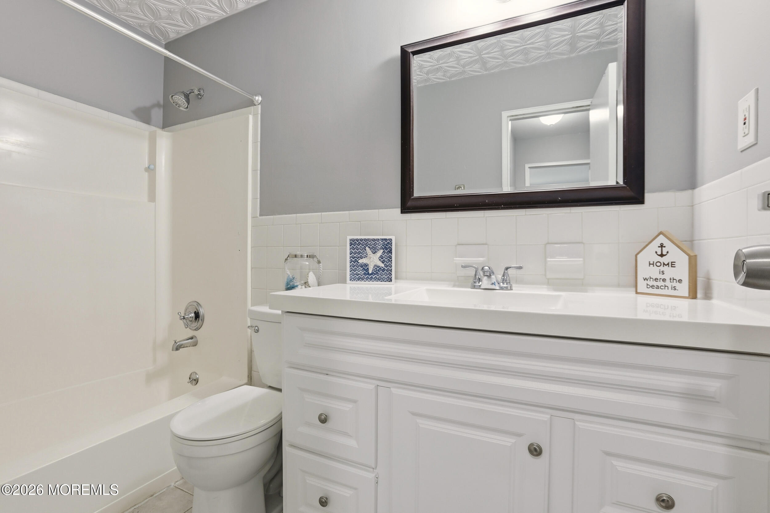330 Shore Drive, Unit B7 Highlands, NJ 07732 - Photo 3 of 22 a bathroom with a toilet sink and mirror