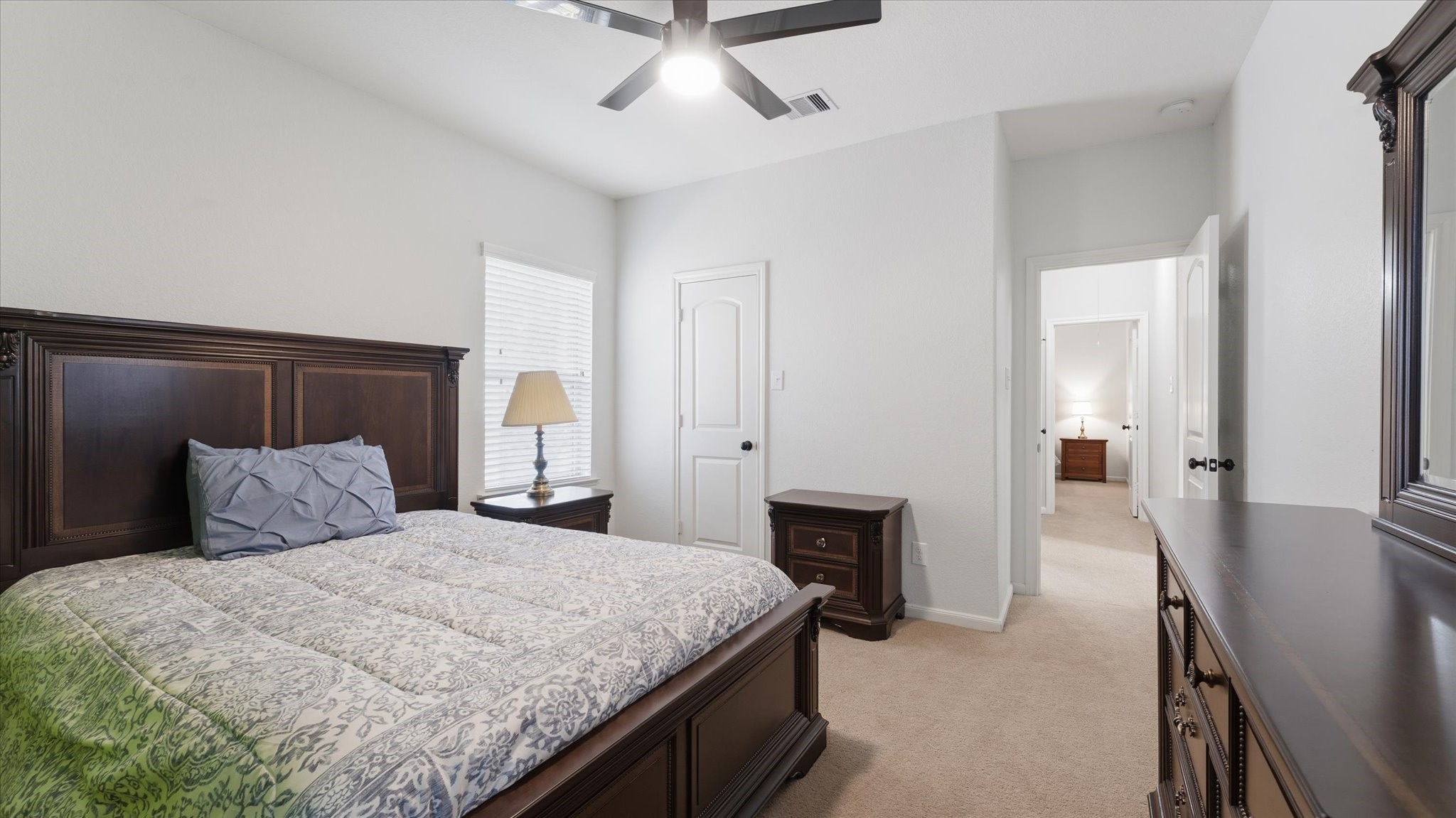 14 Painted Post Place Spring, TX 77389 - Photo 29 of 43 a bedroom with a bed and a chandelier