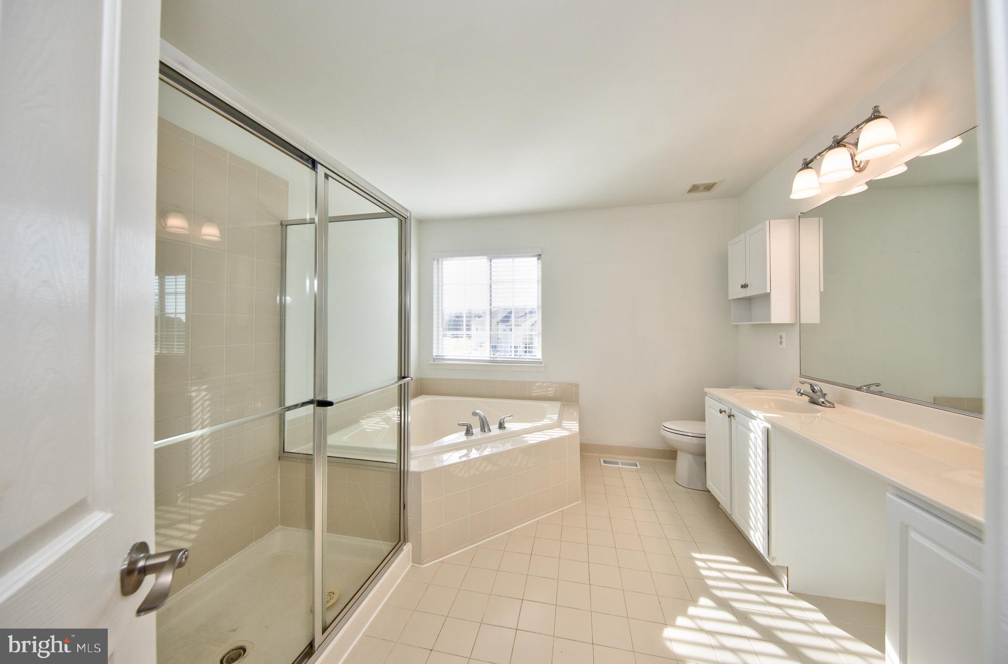 580 Callander Way Abingdon, MD 21009 - Photo 15 of 31 a spacious bathroom with a tub sink and mirror