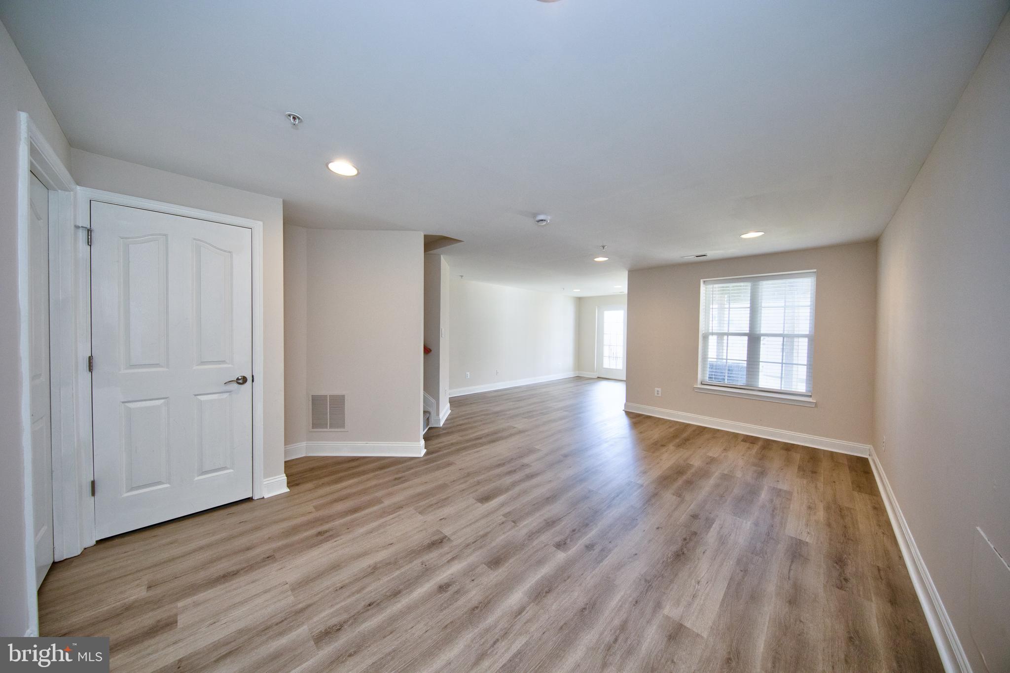 580 Callander Way Abingdon, MD 21009 - Photo 23 of 31 a view of an empty room with wooden floor and a window
