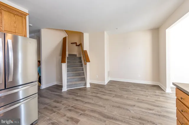 a view of an empty room with a kitchen