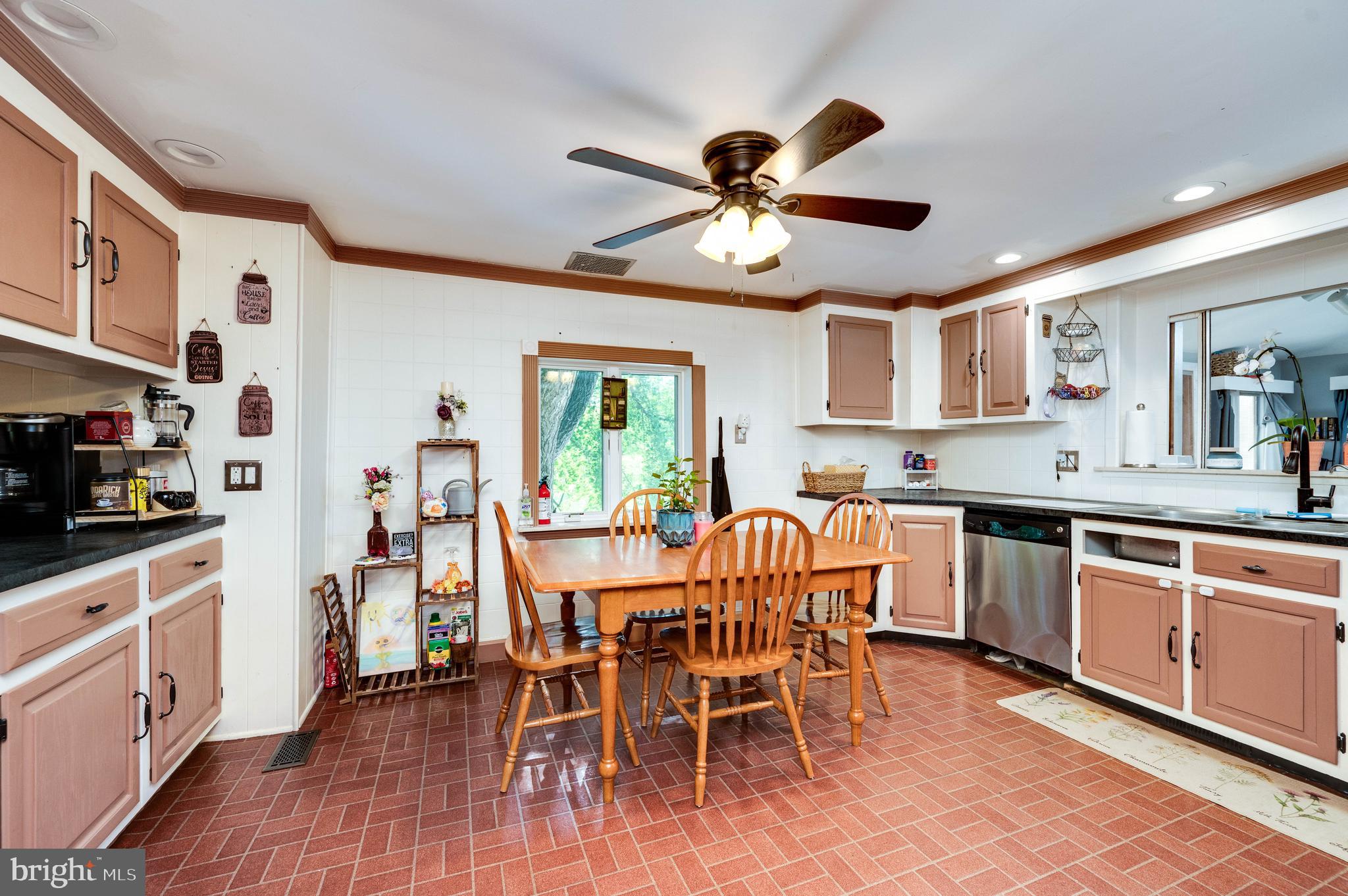 568 North Church Road Reading, PA 19607 - Photo 14 of 56 a open kitchen with stainless steel appliances kitchen island granite countertop a table chairs sink and cabinets