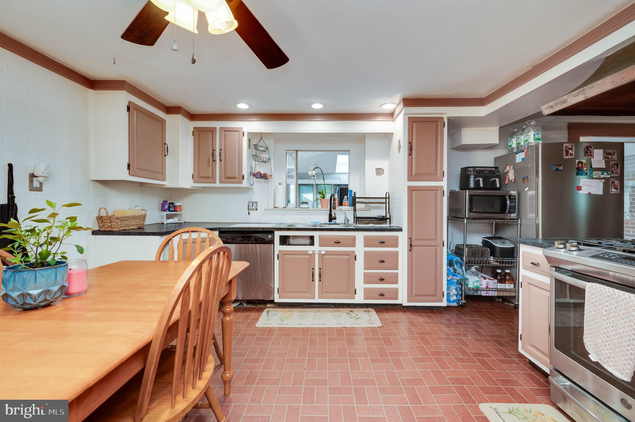 568 North Church Road Reading, PA 19607 - Photo 16 of 56 a kitchen with a table chairs refrigerator and microwave