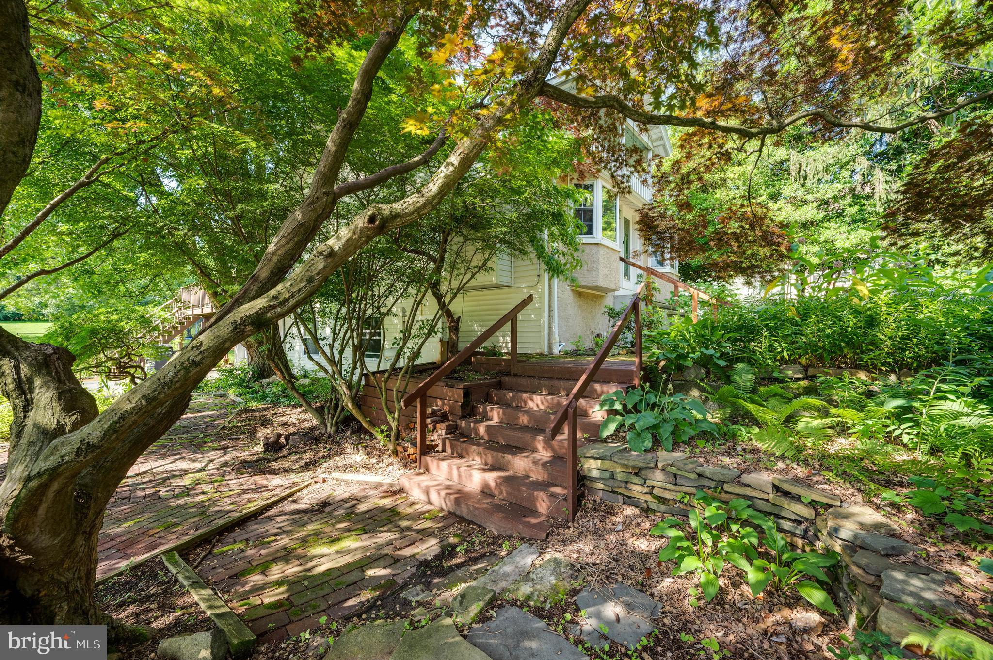 568 North Church Road Reading, PA 19607 - Photo 50 of 56 a backyard of a house with table and chairs under a large tree