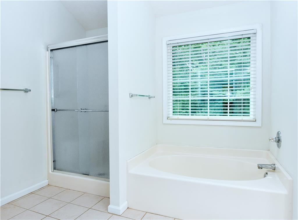 795 Sunset Ridge Lane Southeast Lawrenceville, GA 30045 - Photo 17 of 47 a white bath tub sitting next to a window