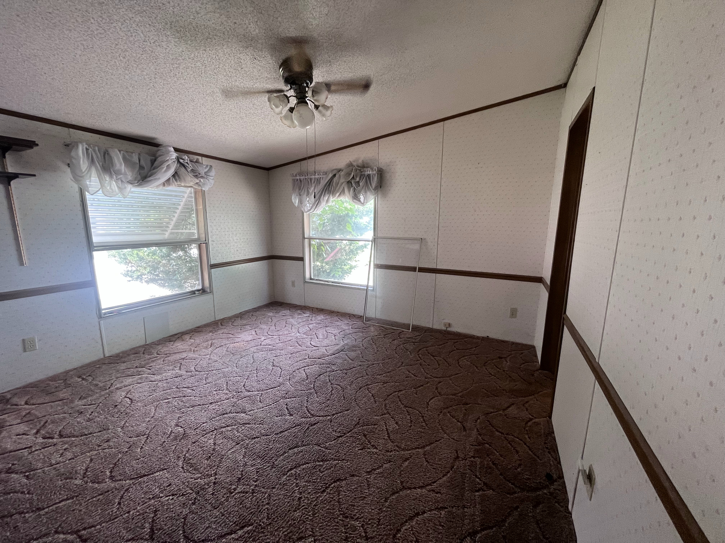 8653 Fig Tree Lane Roscoe, IL 61073 - Photo 16 of 22 a view of empty room with windows and fan
