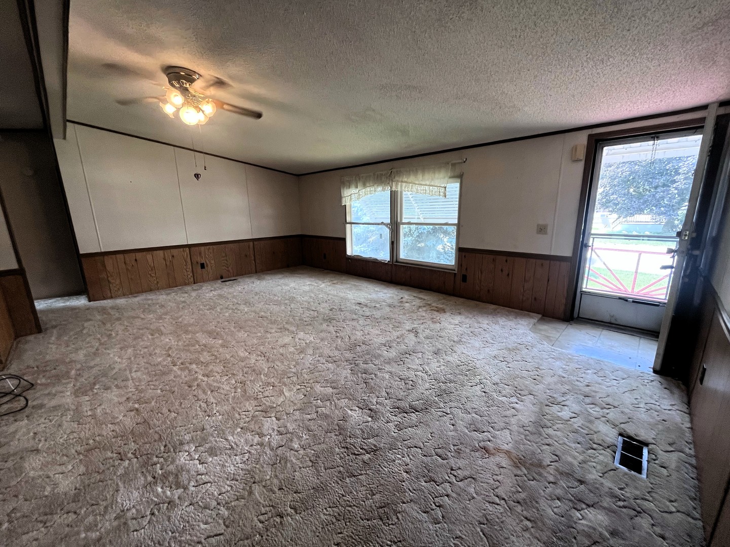 8653 Fig Tree Lane Roscoe, IL 61073 - Photo 3 of 22 a view of an empty room with a window and kitchen view