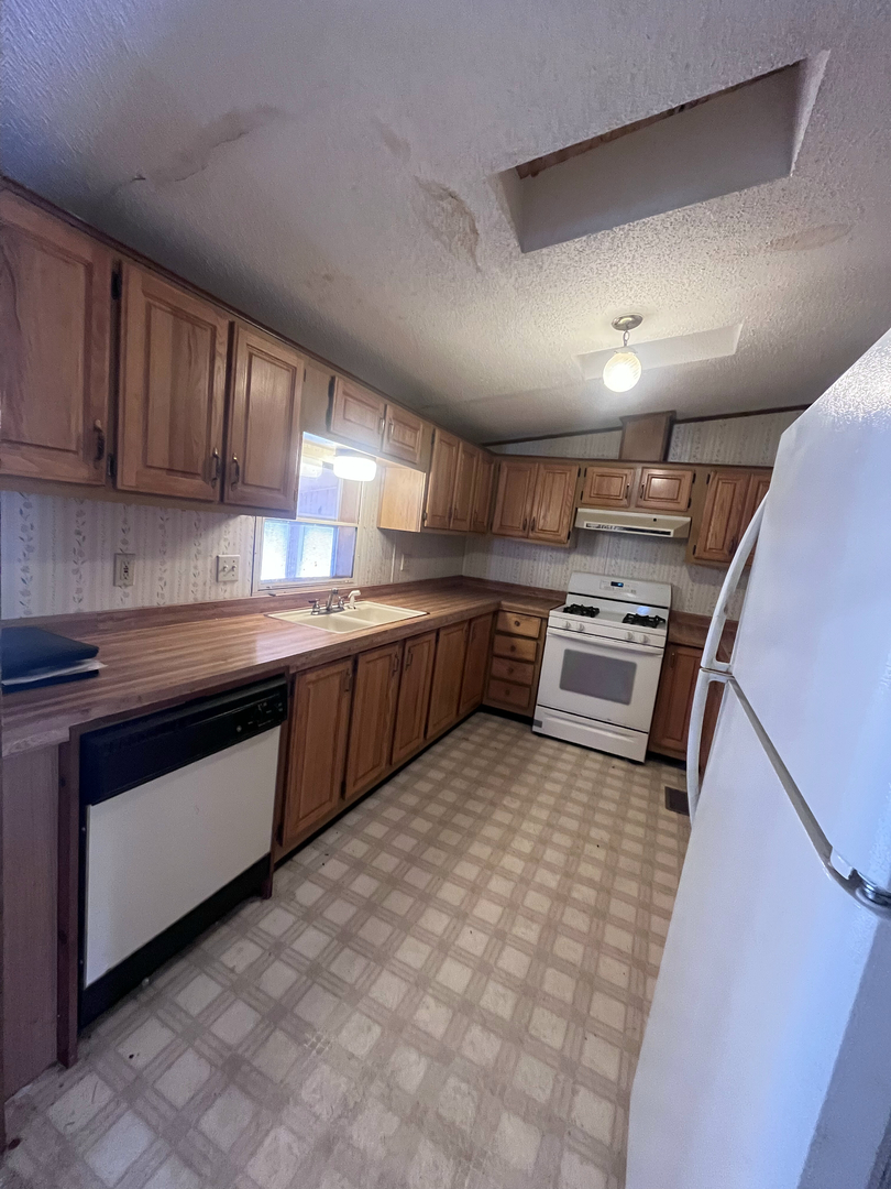 8653 Fig Tree Lane Roscoe, IL 61073 - Photo 6 of 22 a kitchen with stainless steel appliances granite countertop a sink stove and cabinets