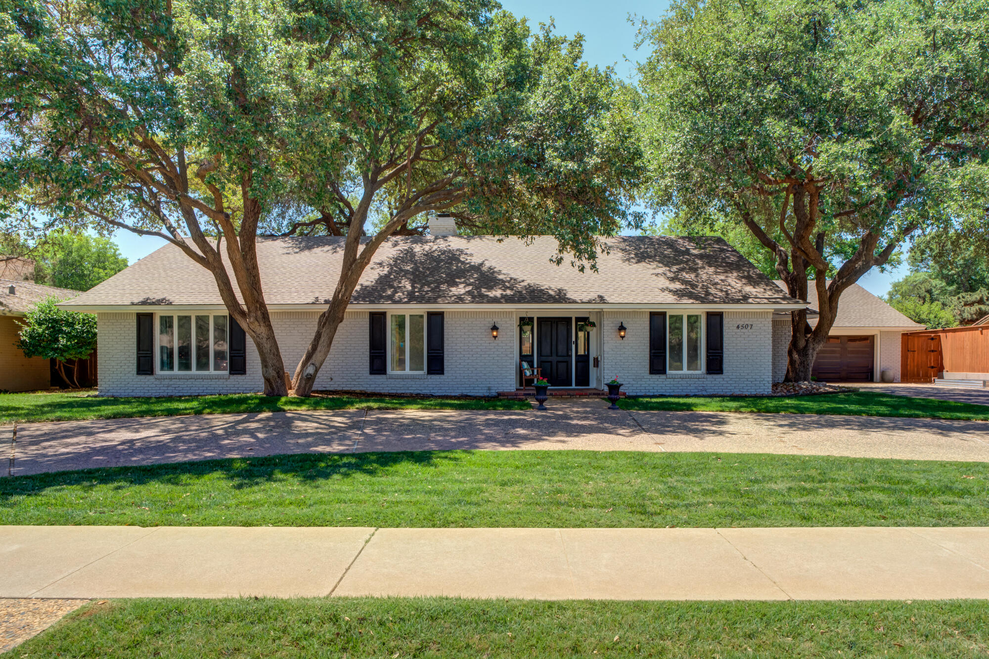 4507 8th Street Lubbock, TX 79416 - Photo 1 of 42 a front view of a house with a yard