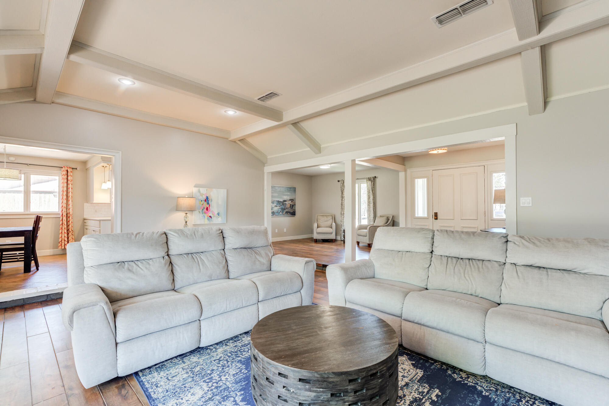 4507 8th Street Lubbock, TX 79416 - Photo 12 of 42 a living room with furniture and a dining table with wooden floor
