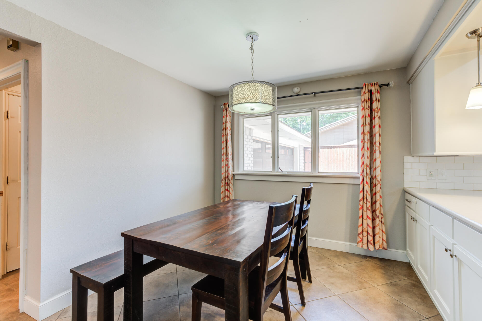 4507 8th Street Lubbock, TX 79416 - Photo 15 of 42 a view of a dining room with furniture window and wooden floor