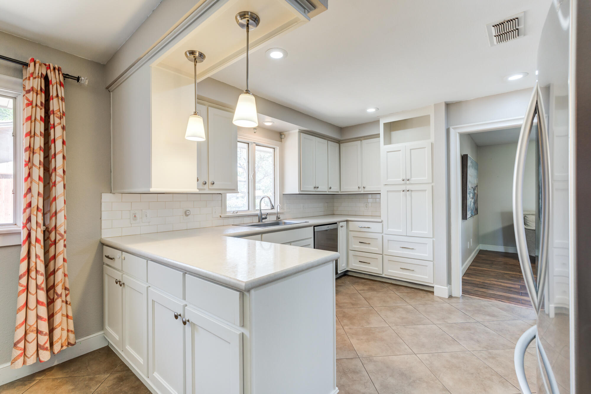 4507 8th Street Lubbock, TX 79416 - Photo 16 of 42 a kitchen with white cabinets and white appliances