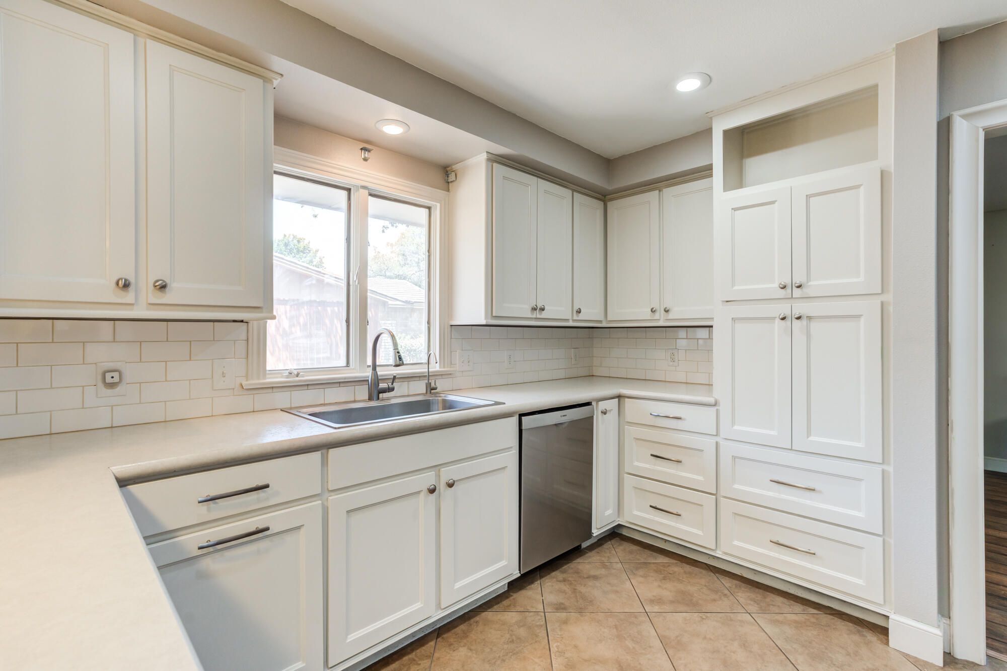 4507 8th Street Lubbock, TX 79416 - Photo 17 of 42 a kitchen with white cabinets and sink