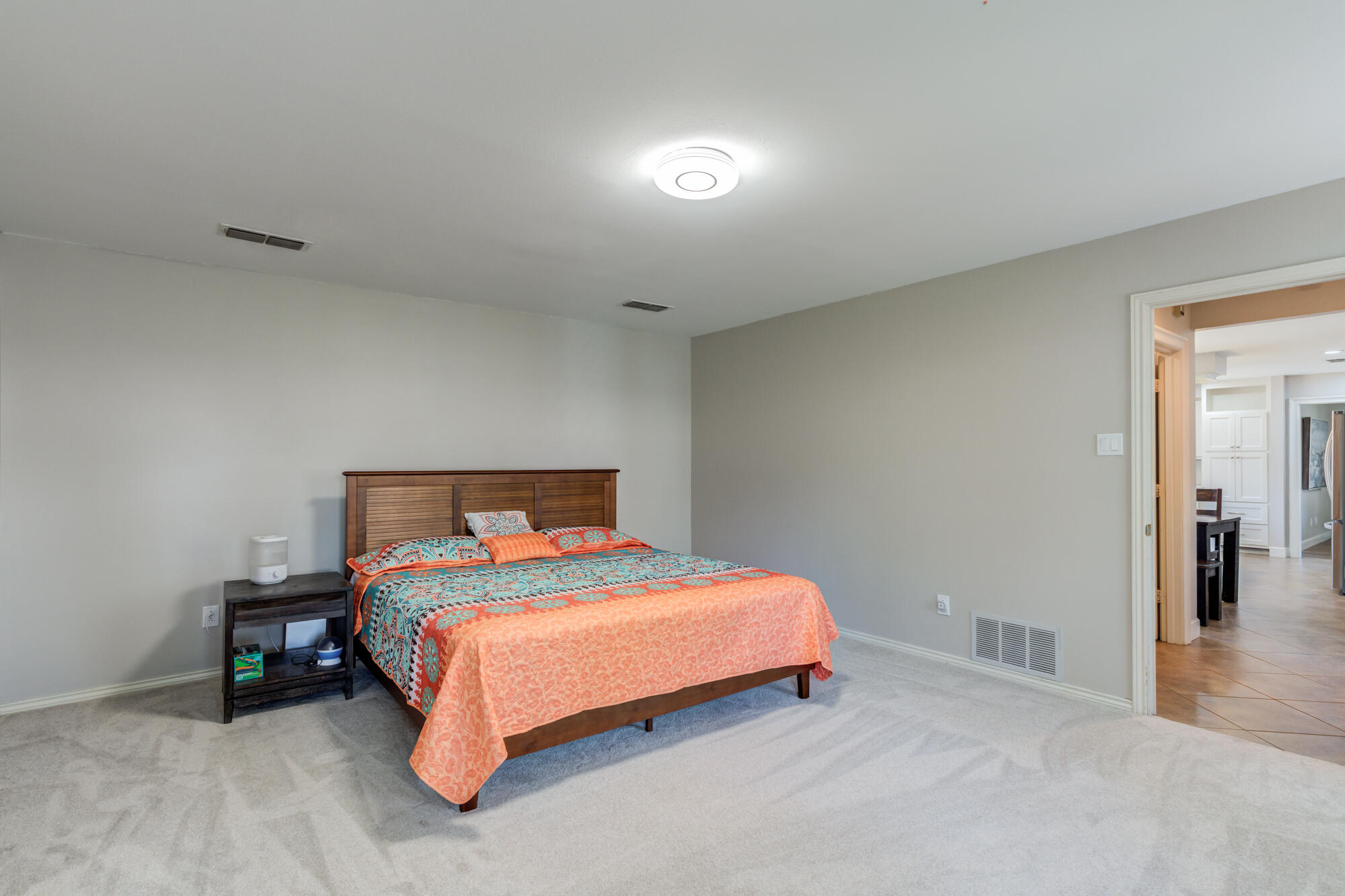 4507 8th Street Lubbock, TX 79416 - Photo 23 of 42 a bedroom with a bed and a table